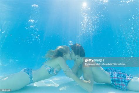 Couple Kissing Underwater In Swimming Pool Photo Getty Images