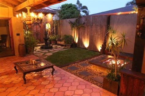 An Outdoor Patio With Lights On The Side And A Table In The Middle