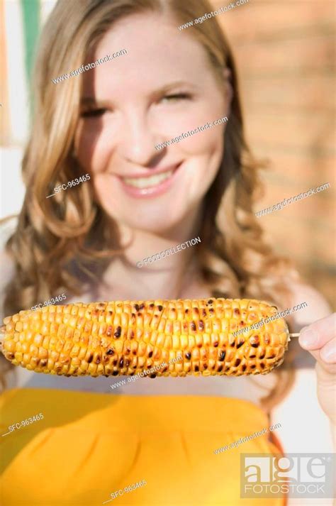 Woman Holding Grilled Corn On The Cob Stock Photo Picture And Royalty Free Image Pic SFC