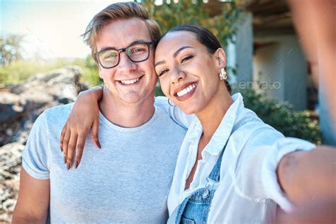 Selfie Of Interracial Couple In Love Smile And Romantic Date With Care Bond And Relax In