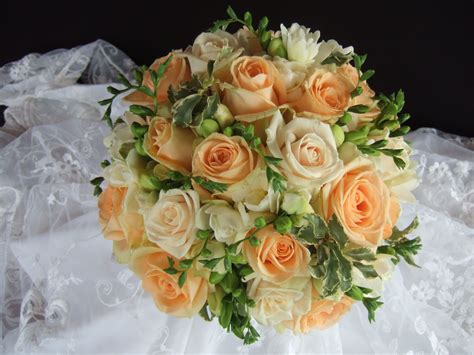 Brides Handheld Bouquet Of Cream Freesia Avalanche Roses Ruscus