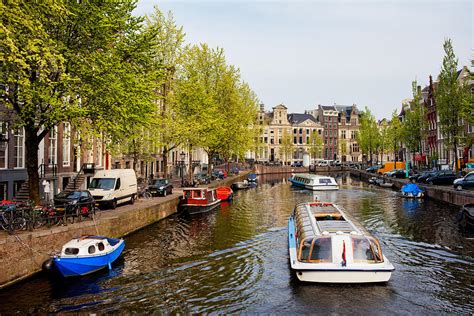 boats on canal tour in amsterdam photograph by artur bogacki fine art america