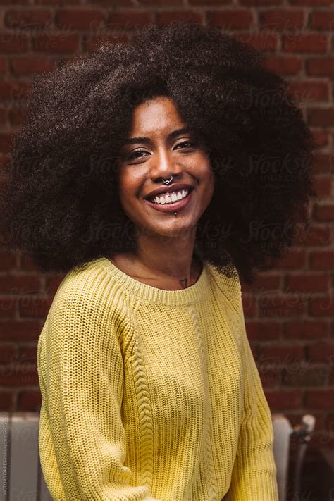 Afro Young Woman Smiling At Camera By Stocksy Contributor Victor