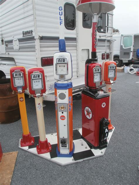 An Assortment Of Gas Pumps In Front Of A Trailer