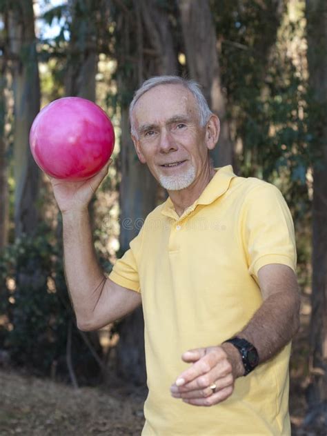Senior Man Throwing Large Ball Stock Image Image Of Recreation