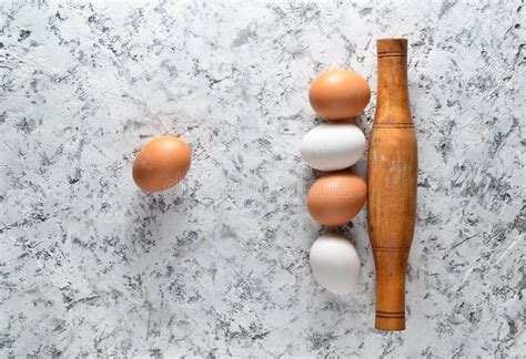 Eggs Rolling Pin On White Concrete Surface The Cooking Process