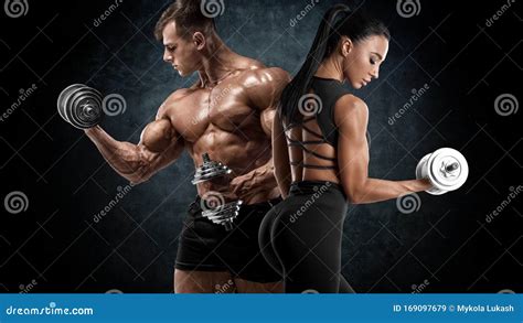 sporty couple workout with dumbbells muscular man and woman showing muscles stock image image