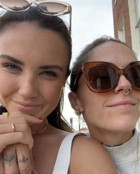 Two Women Wearing Sunglasses Pose For The Camera With Their Fingers On Their Chins