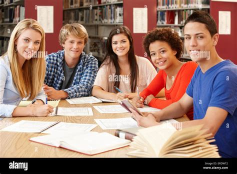 Group Of Students Working Together In Library Stock Photo Alamy