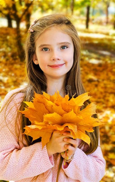 Autumn Portrait Of Adorable Smiling Little Girl Child With Leaves Stock