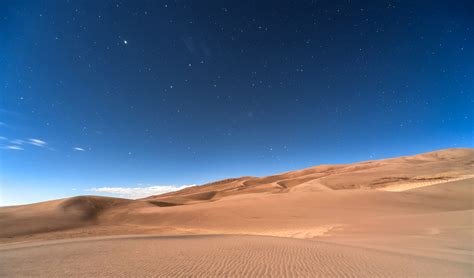 Sky And Stars At Night Above The Desert Landscape In