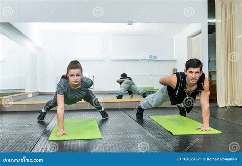 Two People In Gym Doing Plank Exercise Together Stock Image Image Of