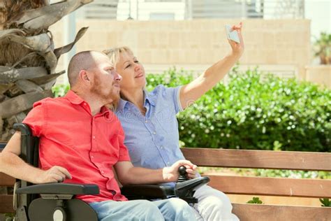 Disabled Man With His Wife Having Fun Taking Selfie Photos Stock Image