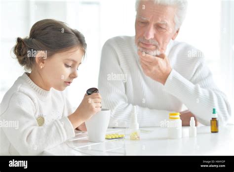 Granddaughter Takes Care Of A Sick Grandfather Stock Photo Alamy