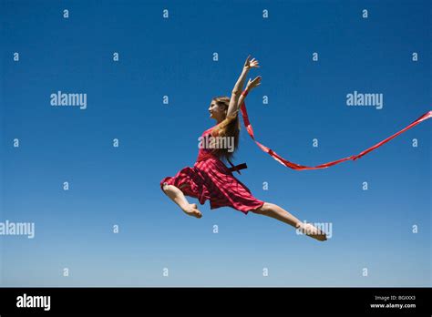 Young Woman Leaping Midair Stock Photo Alamy
