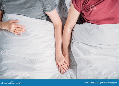 Couple Holding Hands While Lying In Bed Together Stock Image Image Of