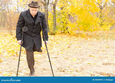 Elderly Disabled Man On Crutches In A Park Stock Image Image 34609951