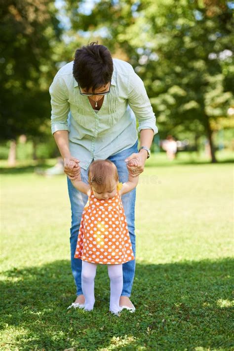 Mother And Baby In Park Making First Steps Stock Photo Image Of