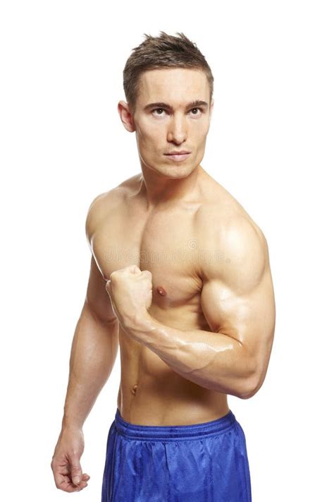 Muscular Young Man Flexing Arm Muscles In Sports Outfit Stock Image