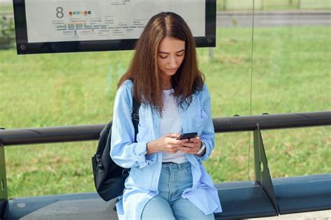 Charming Girl With Trendy Look Use Smart Phone While Waiting On Bus
