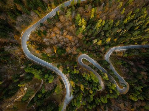 Winding Road In Mountains Fall Woodlands Drone View From Above