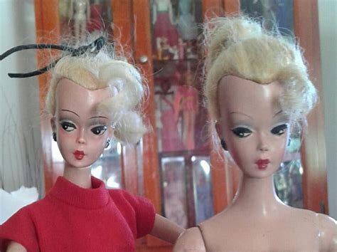 Two Dolls Are Standing Next To Each Other