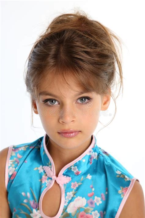 Beautiful Little Girl In An Asian Blue Dress In Fashion