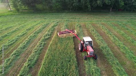 Using A Hyrdoswing Swather A Wisconsin Farmer Cuts A Field Of Alfalfa
