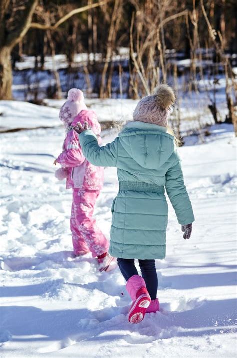 Two Little Kid Girls In Colorful Clothes Playing Outdoors Stock Photo