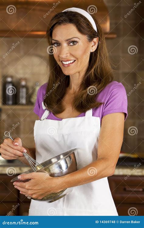 Attractive Woman Mixing Baking In Kitchen Royalty Free Stock Photos