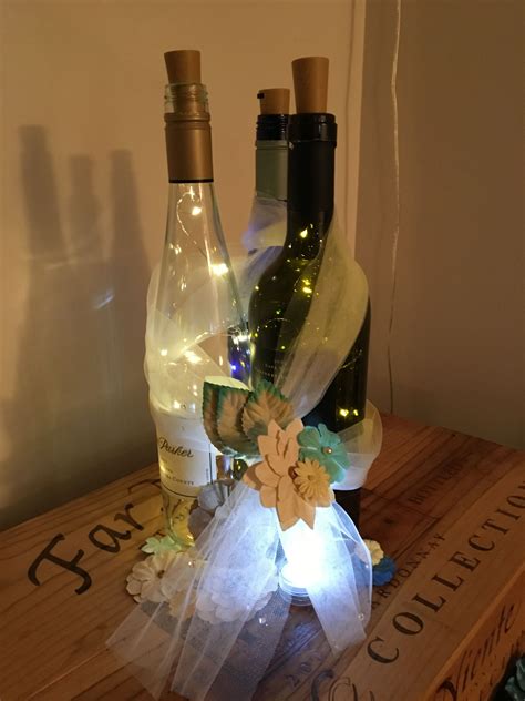 Wine Bottle Centerpieces With Fairy Lights And Flowers Wine Bottle