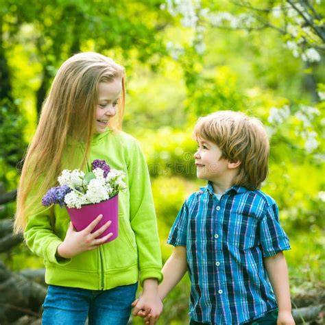 Cheerful Smiling Boy And Girl Look At Each Other And Walk Outdoor