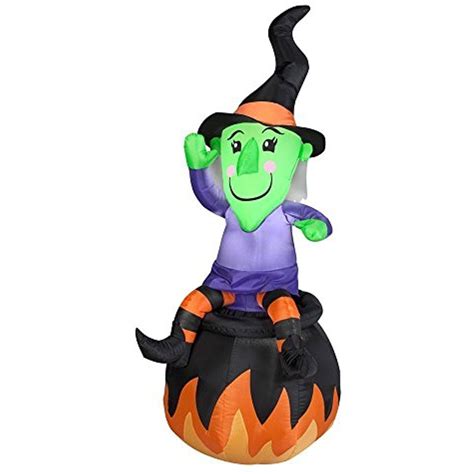 An Inflatable Halloween Witch Sitting On Top Of A Pumpkin