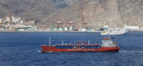 A Red Cargo Ship Cruising On Blue Sea · Free Stock Photo