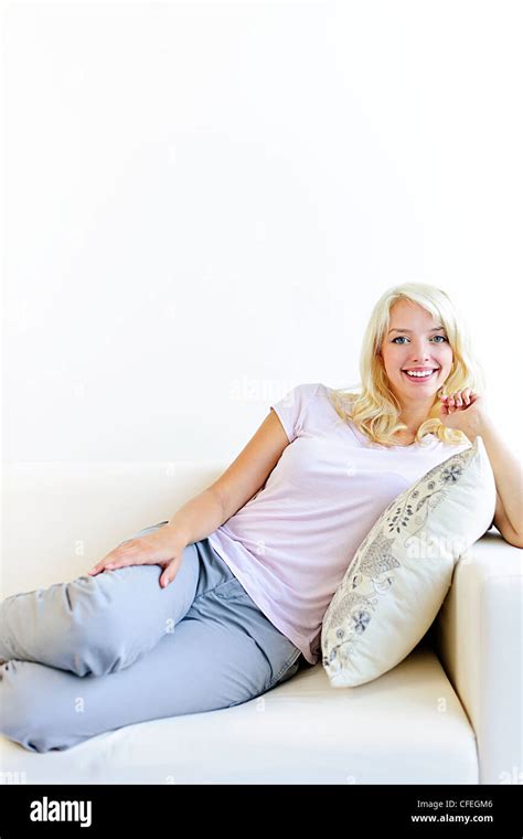 Beautiful Blonde Woman Reclining On Couch And Relaxing At Home Stock Photo Alamy
