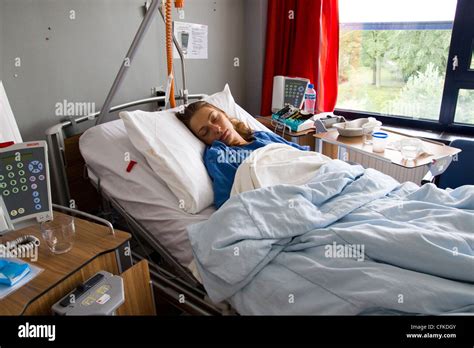 Young Woman Recovering From Operation In Hospital Bed Stock Photo Alamy