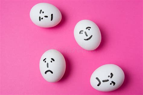 Eggs With Different Faces On A Pink Background With Copy Space The