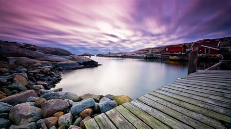Colorful Houses Near River With Wooden Dock Under Purple Sky In Swedish ...