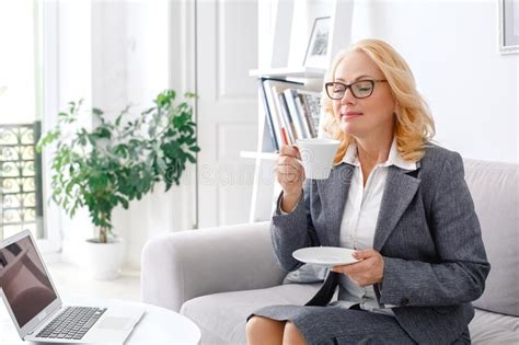Woman Psychologist Portrait Sitting At Casual Home Office Smelling