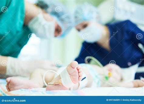 Neonatal Resuscitation Doctor`s Team Doing Intensive Therapy To