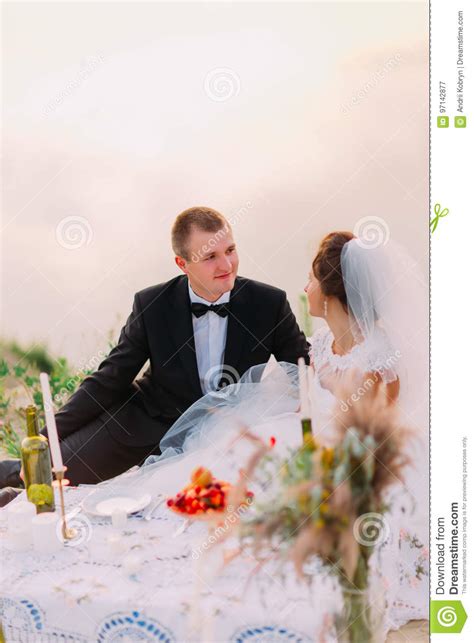 The Newlywed Couple Is Enjoying The Wedding Picnic Near The Sea Stock