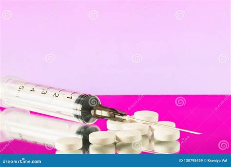 injection syringe with needle and white pills on pink background stock image image of healthy