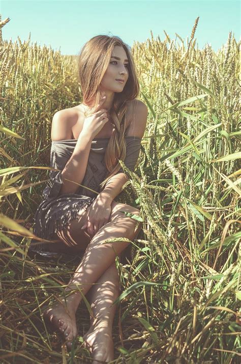 A Woman Is Sitting In The Tall Grass