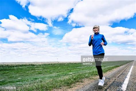 Woman Runner On Highway Photos And Premium High Res Pictures Getty Images