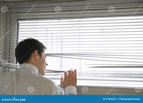 Businessman Looking Through Blinds Stock Image Image Of Corporate
