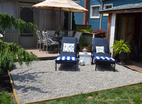 So we were done with rock landscaping…until i decided that i liked the clean look of the rocks and pavers so much that i decided to extend it all around the entire deck. Backyard Makeover - Pea Gravel Patio - Red Cottage Chronicles