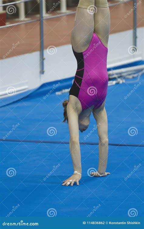 Young Female Gymnast Doing A Handstand At The Stadium Editorial