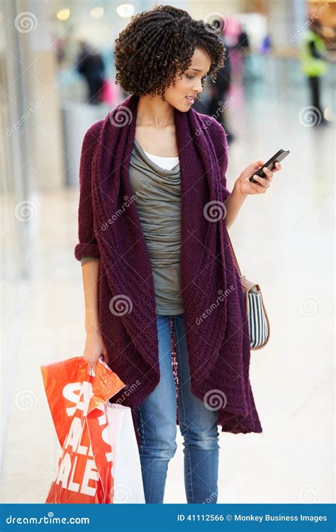 Woman In Shopping Mall Using Mobile Phone Stock Photo Image Of Choice