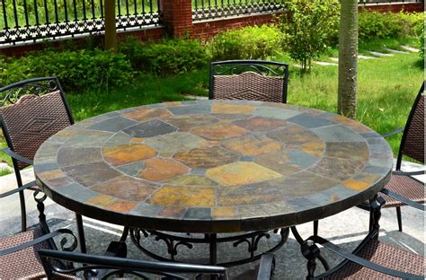 The table has a center hole to accommodate an umbrella. 125-160cm Round Slate Patio Dining Table Tiled Mosaic - OCEANE