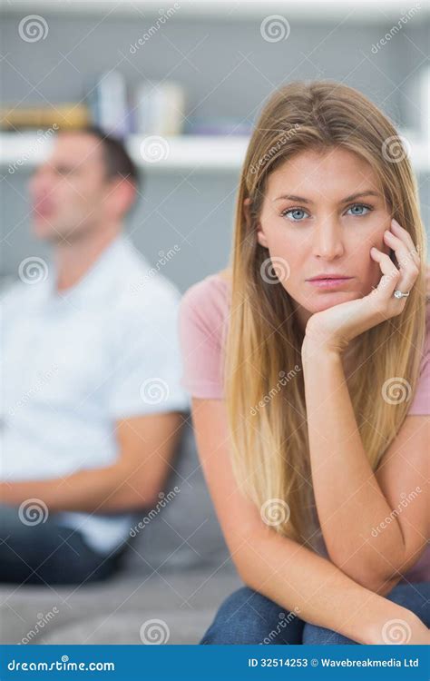 Couple Not Talking After A Dispute On The Couch With Woman Looking At
